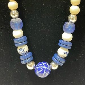 Gorgeous wouldn’t be on the beige area and glass blue beads with silver 13.5 inc